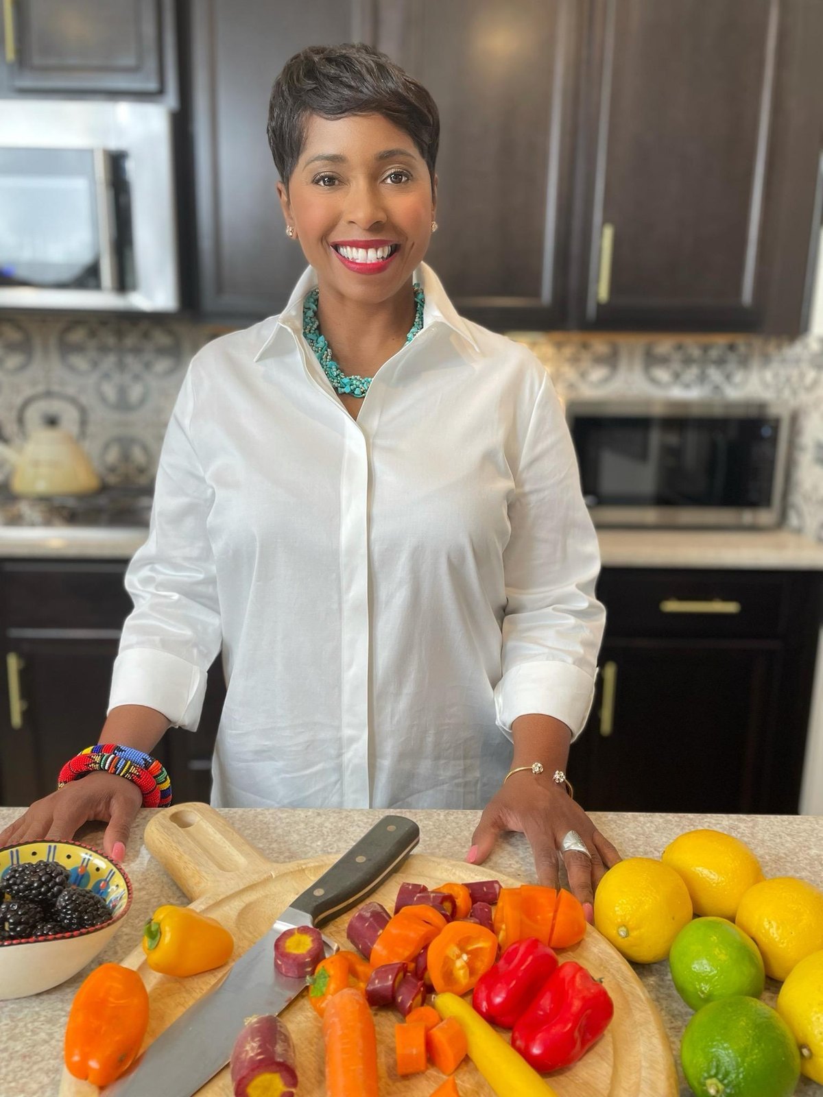 Dr. Natasha Ryan, ND, preparing fresh vegetables in her kitchen